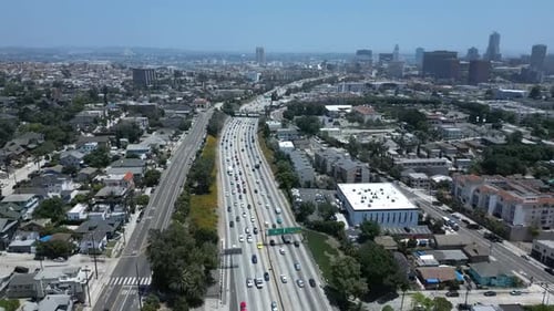 60FPS Drone Flying by Los Angeles Freeway with Cars Driving near LA Skyline Daytime