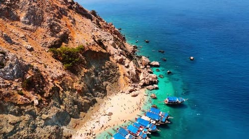 Boats on turquoise beach. Boats are docked near a sandy beach