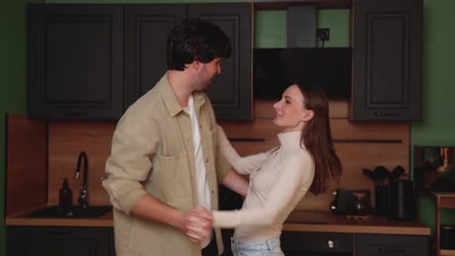 Happy Couple Dancing Together in Kitchen