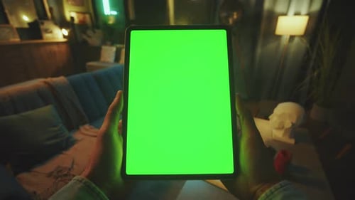 Hands Man Holding Scrolling and Tapping on Tablet Computer with Vertical Green Screen Mockup Display