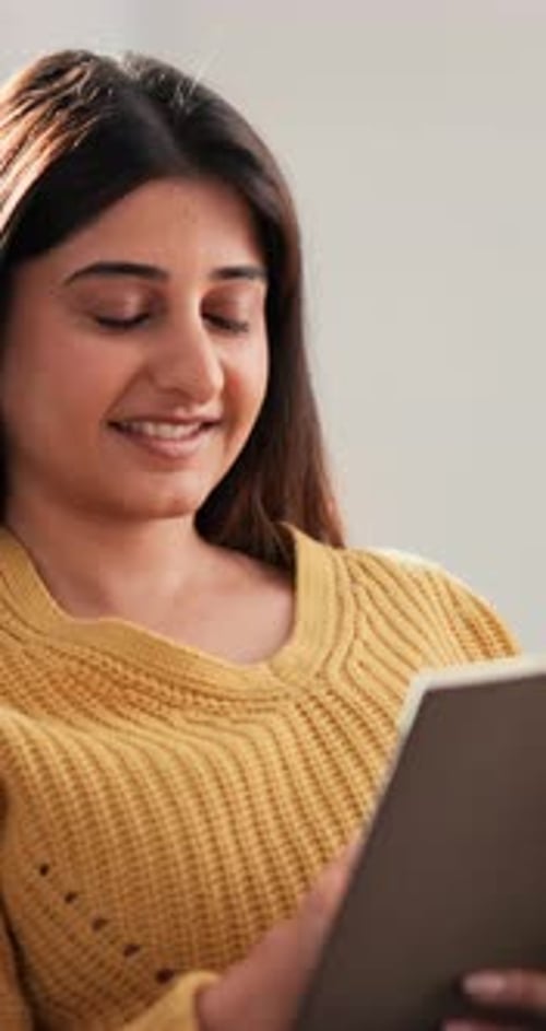 Woman Using Tablet Device in Cozy Home Setting