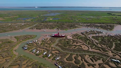 Trinity Light Ship Moored Among Marshes Of Woodrolfe Creek Near Tollesbury In Essex, UK. aerial