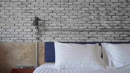 Tilt down on hotel bed and room interior