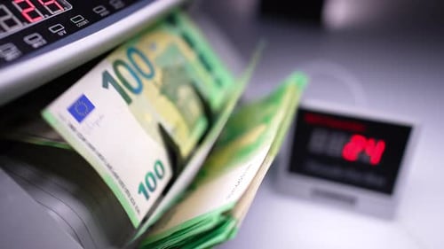 Money Counting Machine Counts Stack of Euro Banknotes
