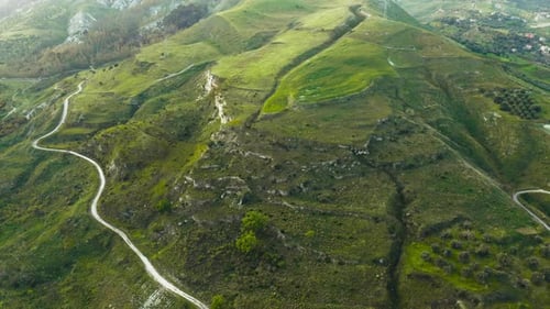Verdant Green Mountains and Winding Roads from Above