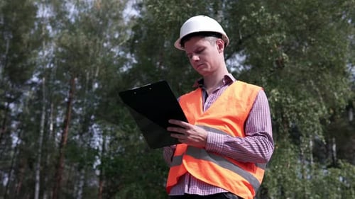 An employee of the energy structure inspects energy equipment and power lines.
