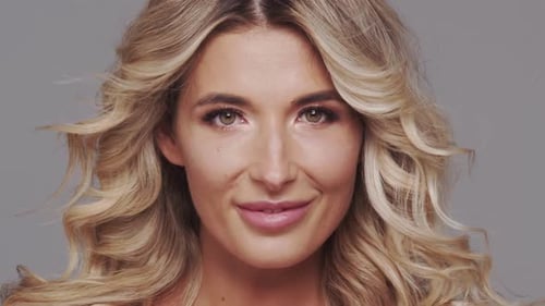 Studio Portrait of Young and Beautiful Blond Woman Over Grey Background Skin Care and Wellness