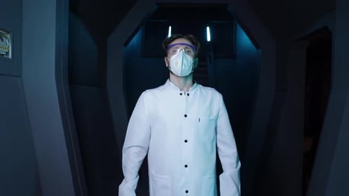 Medical Worker Wearing Uniform Glasses and Mask While Walking Along a Corridor