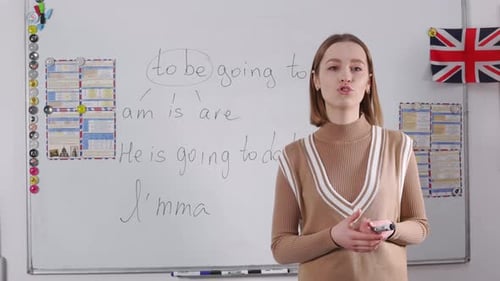 Young Woman Explains English Grammar on White Board
