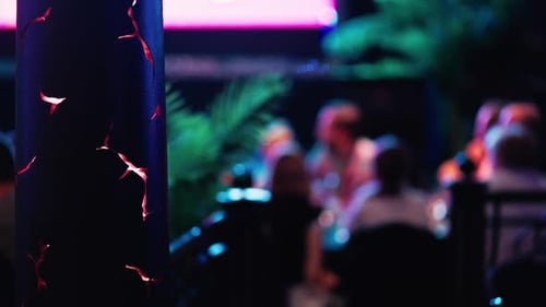 Restaurant Ambience With Blurry Patrons and Tropical Decor