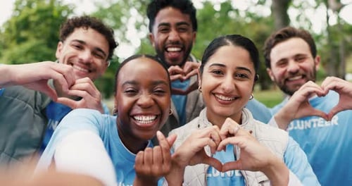 Smiling Group of Volunteers Making Heart Hand Gestures