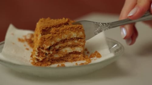 Fork Cutting Delicious Layered Cake Close Up