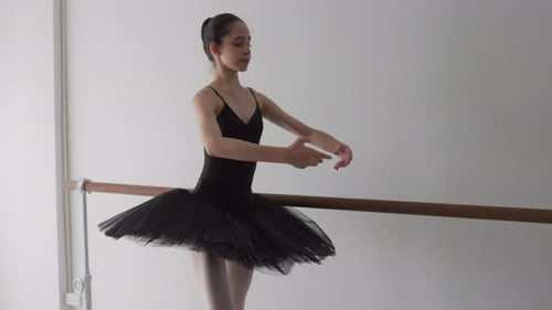Young Ballerina Practicing Ballet at the Barre