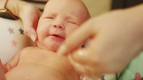 Joyful Infant Getting a Bath in Basin