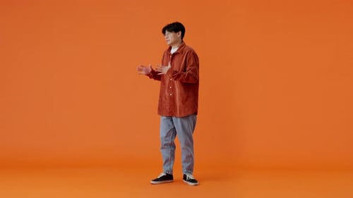 Panicking Asian Male Calming Himself Down with Breathing Out