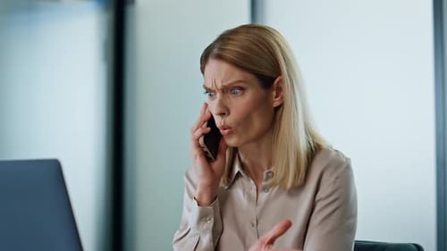 Furious Woman Arguing on Phone in Office Setting