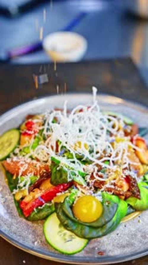 Beautiful vegetable salad is sprinkled with some cheese. Cooking healthy food recipes. Close up.