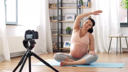 Pregnant Woman Recording Yoga Video in Living Room