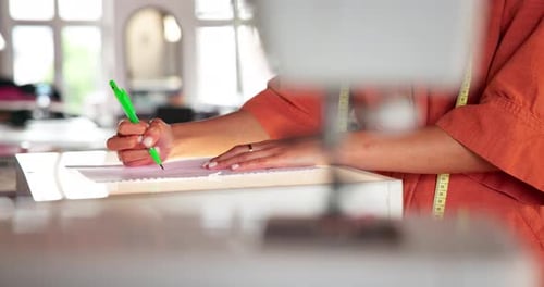 Fashion Designer Drawing on Paper in Studio