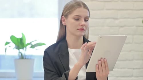 Woman Uses Tablet in Corporate Workplace Setting