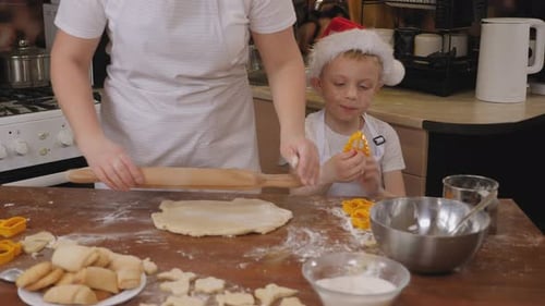 Woman and Child Making Christmas Cookies in Kitchen