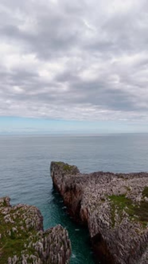 Descending over the dangerous cliff rocks at the shore of the sea.