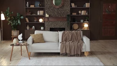 Modern Stylish Spacious Living Room with Sofa on the Background of Brown Wall with Brick Fireplace