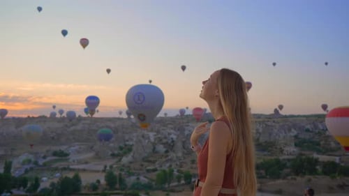 Tourist Woman Looking at Hot Air Balloons in Cappadocia Turkey Happy Travel in Turkey Concept Woman