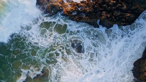 Poderosas olas oceánicas que chocan, rocas costeras, primer plano, agua de mar agitada