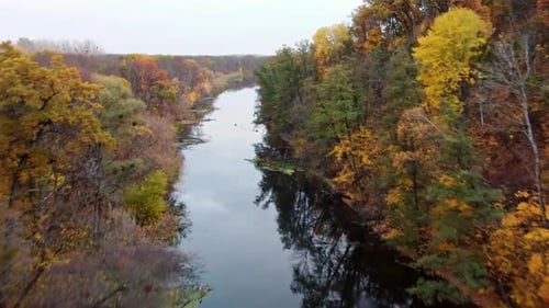 Autumn aerial above river with wooded riverbanks