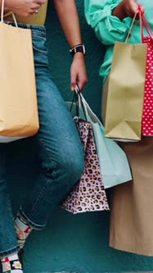 Friends, hands and women with shopping bags at wall for fashion discount, clearance sale or special