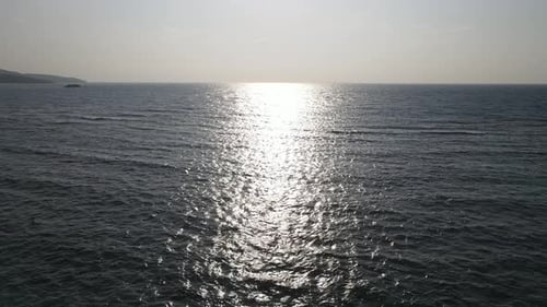 Beautiful aerial sunset view over sea surface beautiful wave. Amazing light sunset or sunrise sky