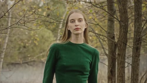 Model posing for photoshoot in autumn forest