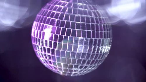 Shiny Disco Ball Reflecting Purple Light