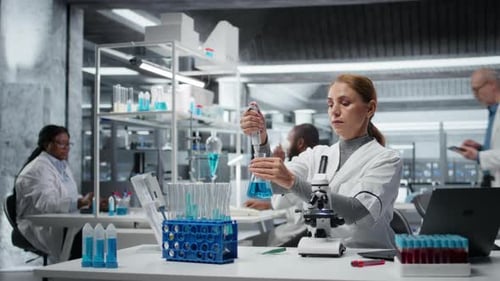 Scientists Working in Laboratory Analyzing Samples and Data