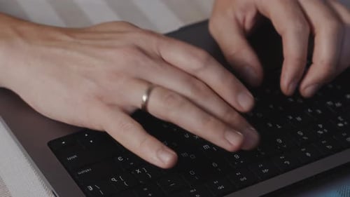 Close Up of Male Hands Pressing Laptop Keyboard Keys