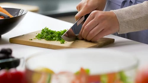 Chopping fresh herbs for a vibrant salad