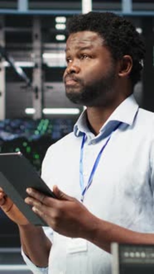 Vertical Video Data Center Engineer Using Tablet to Interpret AI Generated Data Analytics Graphs