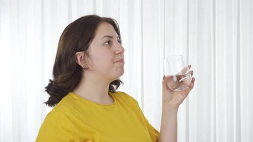 Happy woman sipping water.