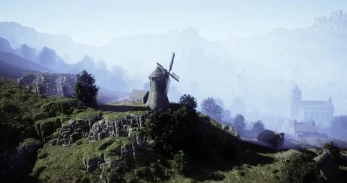Historic Windmill Stands on a Hill Surrounded By Misty Mountains at Dawn