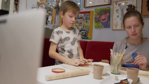 Mother with Son working with clay at home during Remote Ceramics Workshop