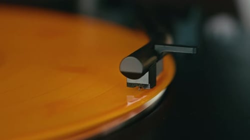 Orange Vinyl Record Spinning on Turntable