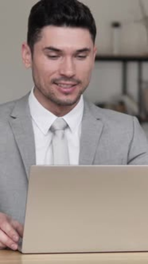 Smiling Businessman Video Conference in Office Setting