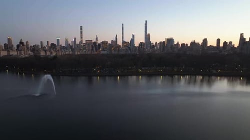 Aerial view the reservoir and the Central park, towards the Midtown skyline, dusk in New York, USA