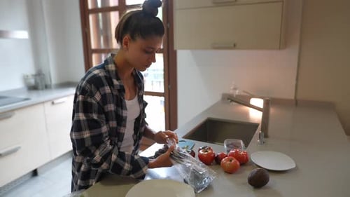 Woman Prepares Healthy Meal in Modern Kitchen