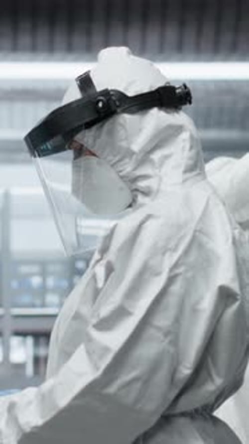 Scientists Working in Laboratory Wearing Protective Gear