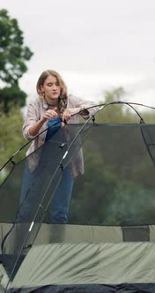 Outdoor, camping and woman in park with tent setup, woods and preparation for adventure