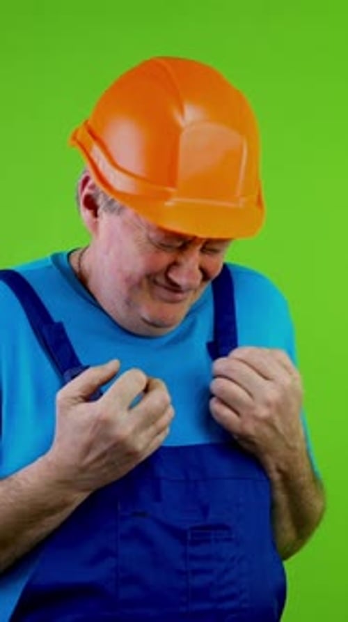 Adult in Hardhat Expressing Discomfort on Green Screen