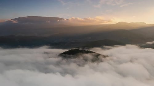 4K video, aerial footage by drone above the misty sea in the valley. morning sun beautiful scenery.