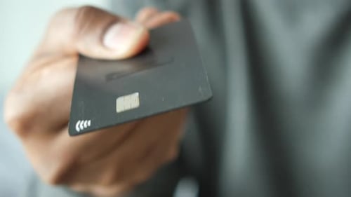 Hand Holding a Wireless Bank Card